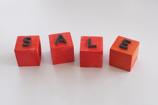 Wooden cube with text sale on the white background