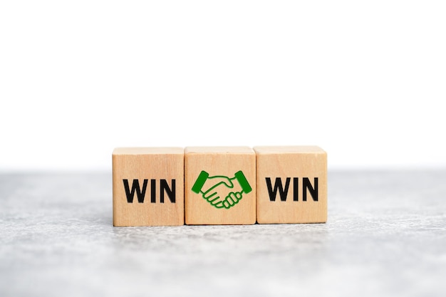 Wooden cube with the word win win with handshake icon, Win win situation in business strategy.