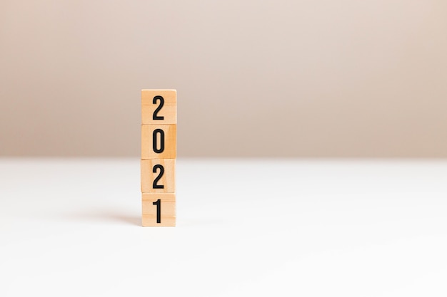 Wooden cubes block with 2021 text on a table background.