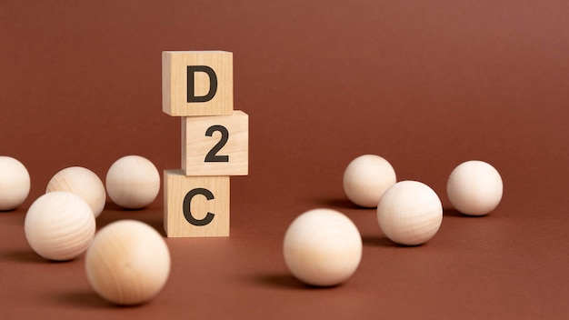 Wooden cubes block with text d2c brown background