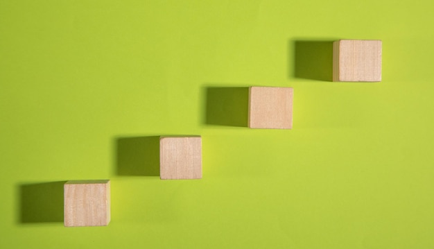 Wooden cubes on the green background