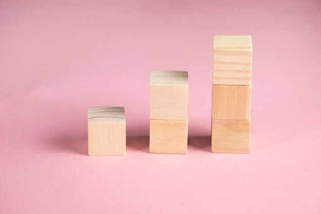 Wooden cubes on pink background