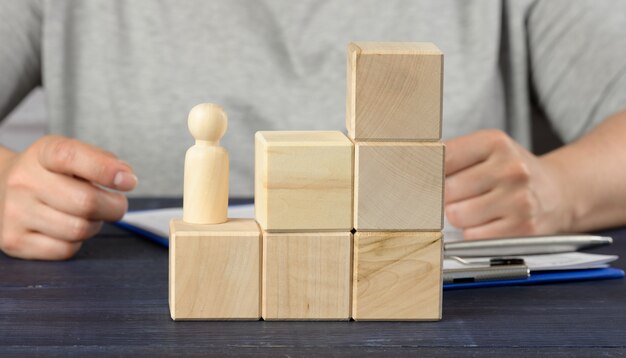 Wooden cubes in the shape of a ladder and a figurine of a man