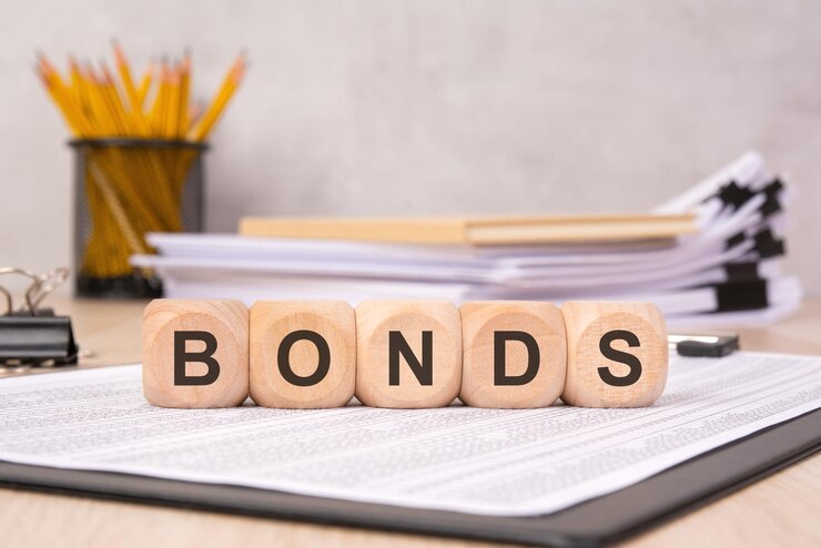 फोटो wooden cubes spelling bonds on an office desk with financial documents symbolizing investment