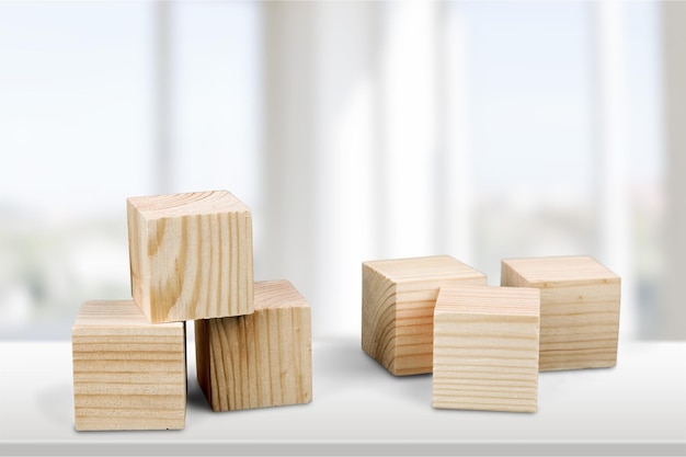 Wooden cubes on table background