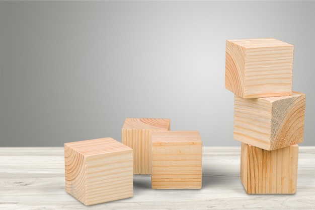 Wooden cubes on table background