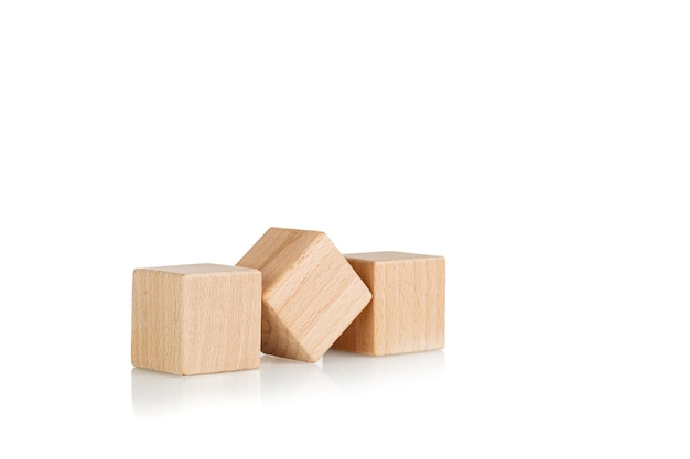 wooden cubes three 3 pieces on an isolate white background closeup