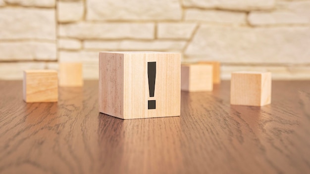 Wooden cubes with exclamation marks on table dark wooden background