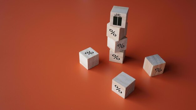 Wooden cubes with gift and percentage sign Loan payment benefits Growth of deposit profitability