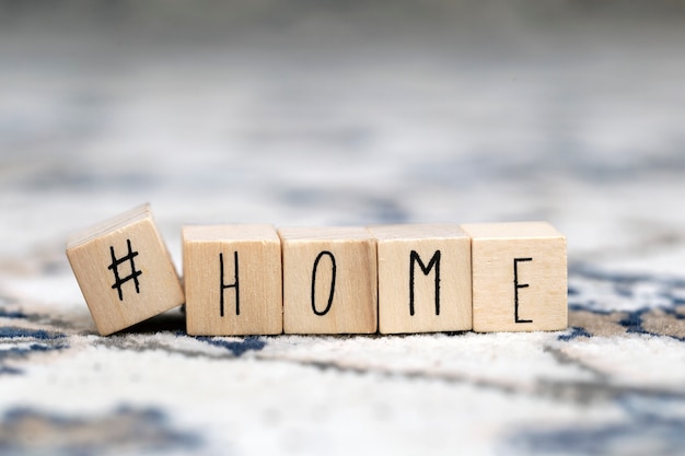 Wooden cubes with Hashtag and the word Home background, social media concept close-up