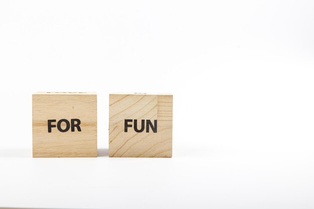 Wooden cubes with the inscription for fun on a white background close up