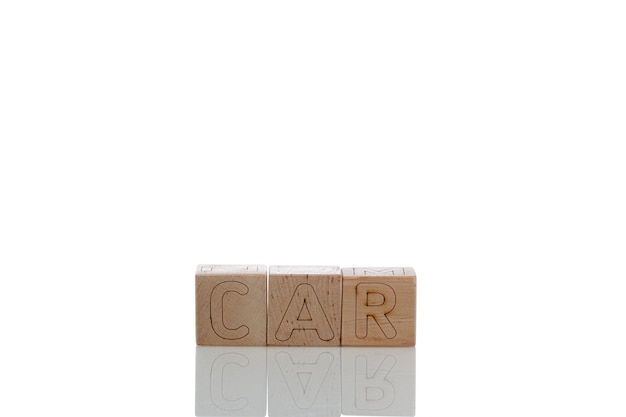 Wooden cubes with letters car on a white background