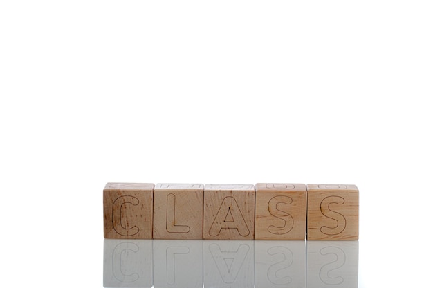 Wooden cubes with letters class on a white background