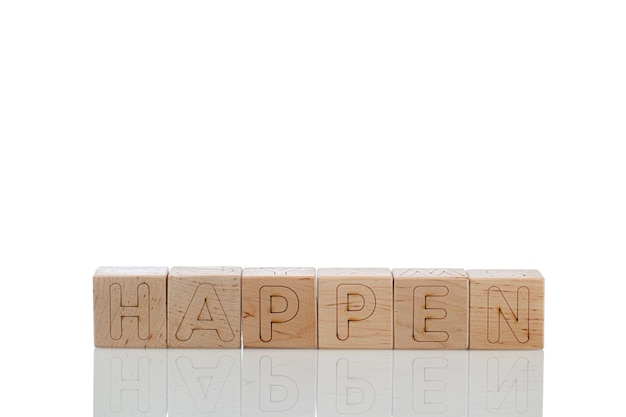 Wooden cubes with letters happen on a white background