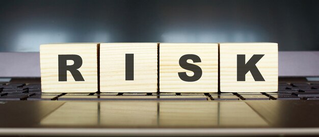 Wooden cubes with letters on a laptop keyboard.