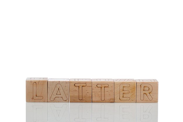 Wooden cubes with letters latter on a white background