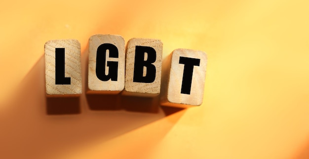 Wooden cubes with letters LGBT on orange lesbian gay bisexual transgender and social media concept background