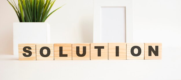 Wooden cubes with letters on a white table