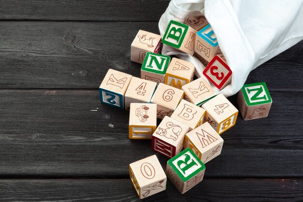 Wooden cubes with letters on wooden table