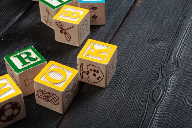 Wooden cubes with letters on wooden table