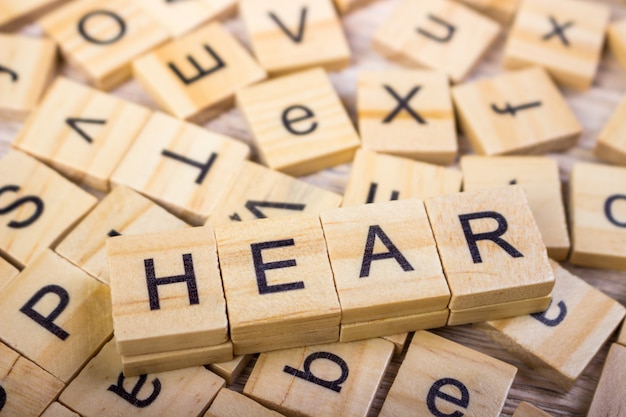 Wooden cubes with letters, the word "Hear"