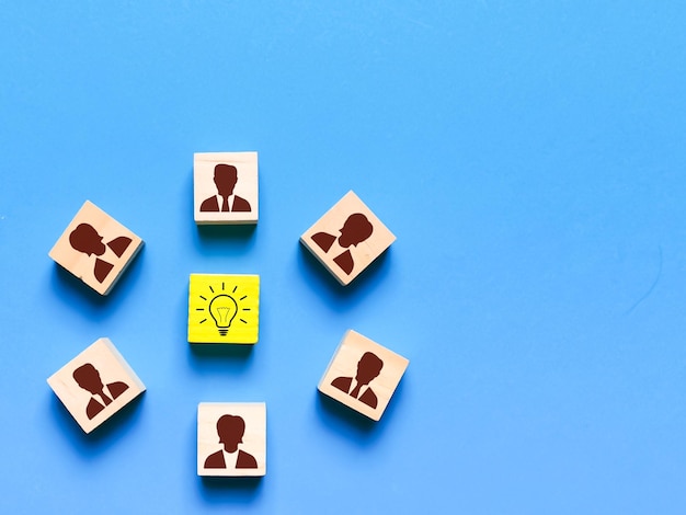 Wooden cubes with light bulb and employee symbols