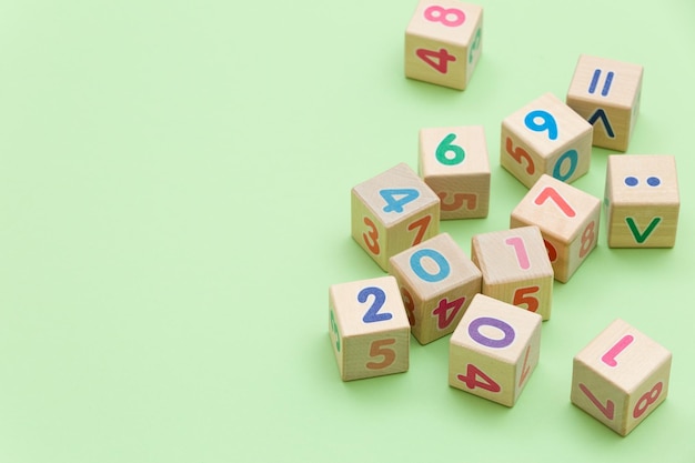 Wooden cubes with numbers on light green background