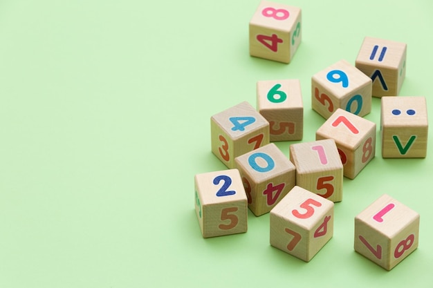 Wooden cubes with numbers on light green background