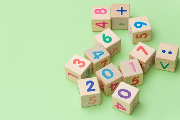 Wooden cubes with numbers on light green background