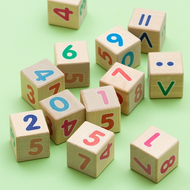 Wooden cubes with numbers on light green background