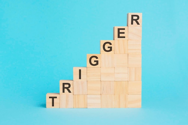 Wooden cubes with text trigger on a blue background