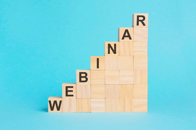 Wooden cubes with text WEBINAR on a blue background