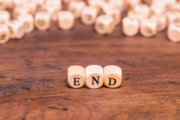 Photo wooden cubes with word end over desk