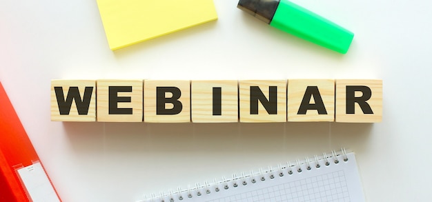 Wooden cubes with word WEBINAR on the office desk