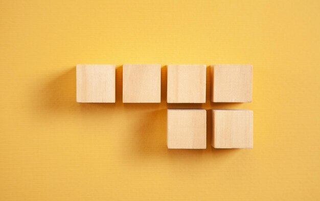 Wooden cubes on the yellow background