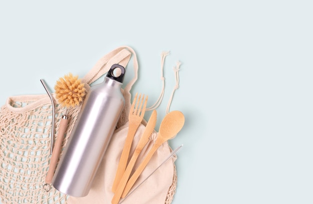 Wooden cutlery on a blue pastel background