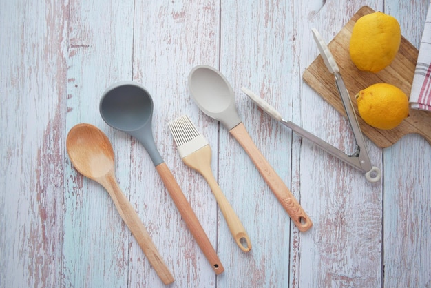 wooden cutlery fork and spoon on a chopping board on table