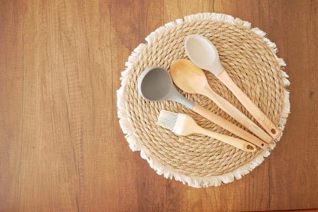 Wooden cutlery forks on light yellow background