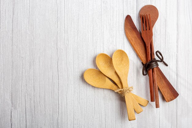 Wooden cutlery on wooden table