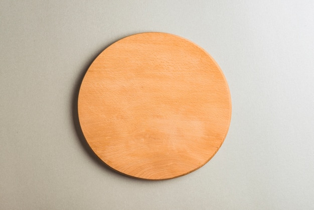 Wooden cutting board on gray backdrop