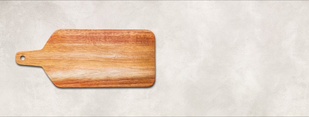 Wooden cutting board isolated on white concrete background. Horizontal panoramic banner