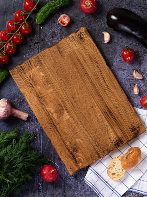 Wooden cutting board linen textile and cutlery Food background with copy space Table top view