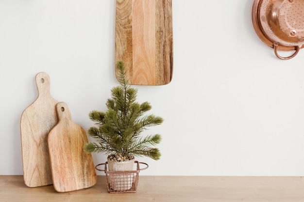 Wooden cutting board near white wall