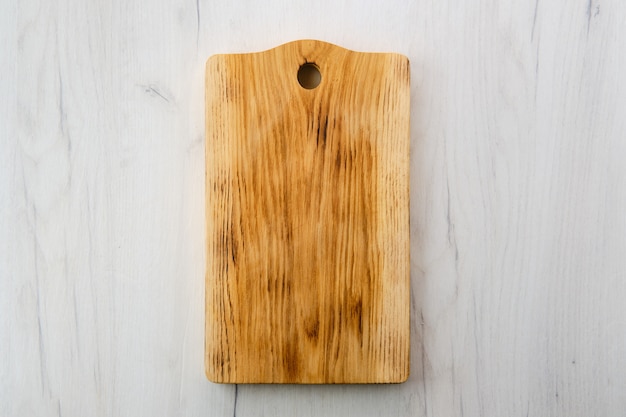 Wooden cutting board on a white table