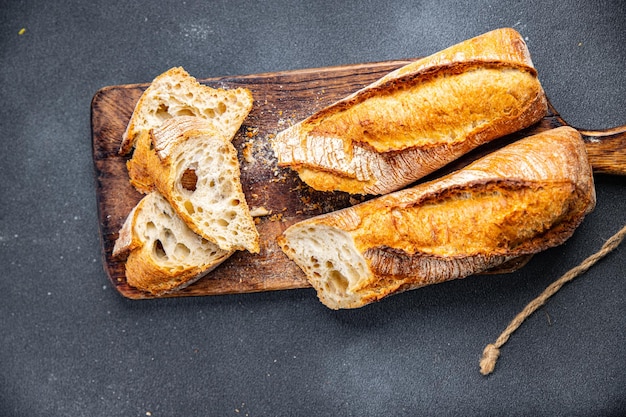 A wooden cutting board with baguette on it