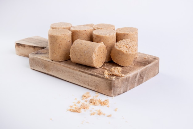 Wooden cutting board with sweets made from peanuts known in Brazil as paÃ§oca.