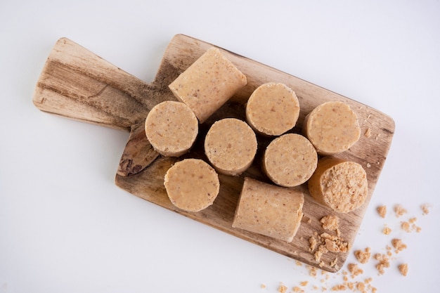 Wooden cutting board with sweets made from peanuts known in Brazil as paÃ§oca.