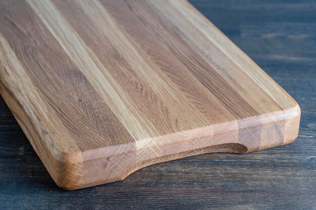 Wooden cutting board on wooden table background