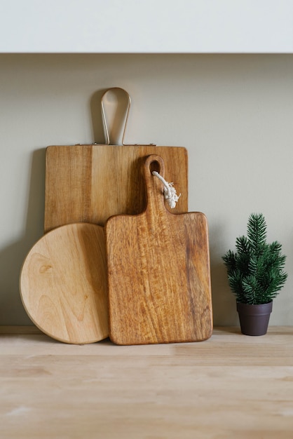 wooden cutting boards of various shapes and a small Christmas tree in a pot