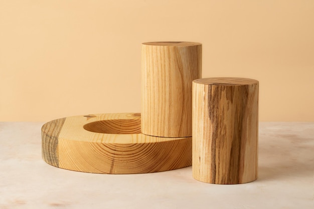 Wooden cylinders and ring on the isometric pastel background